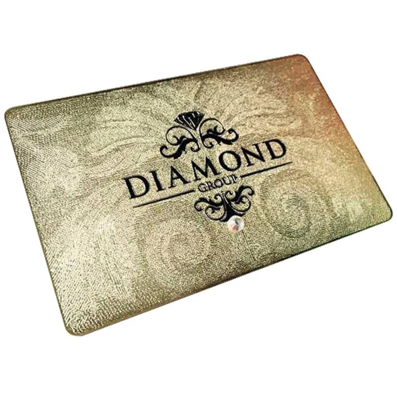 Sandblasted gold card with ornate logo and crystal inlay