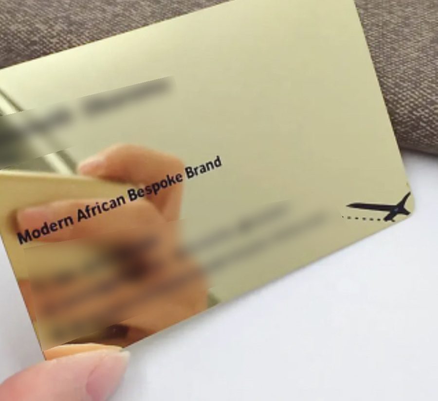 Mirror gold card with engraved type and custom icon; personal details blurred